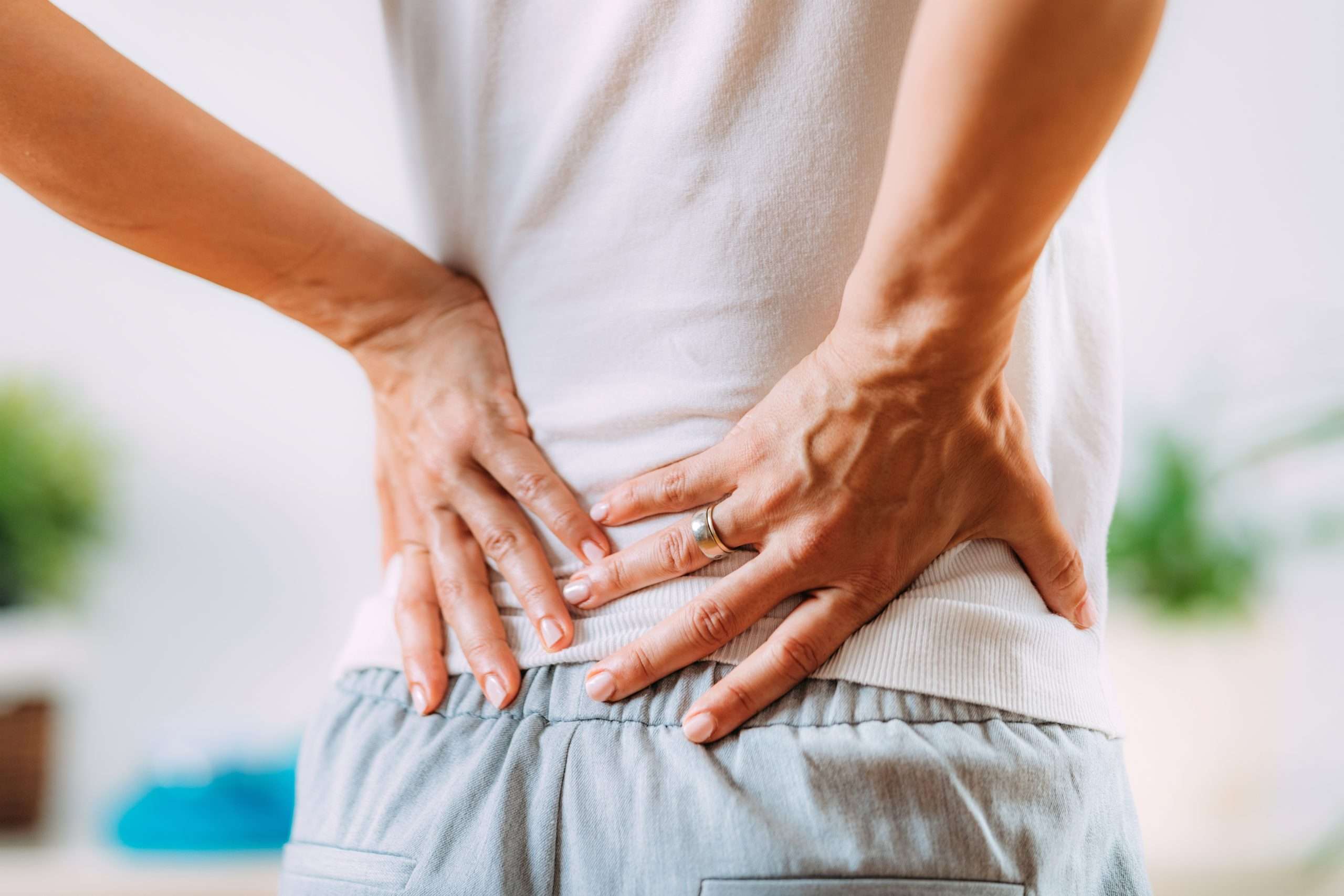 Sciatica or sciatic nerve inflammation, lower back pain. Woman with sciatic nerve pain in her lower back.