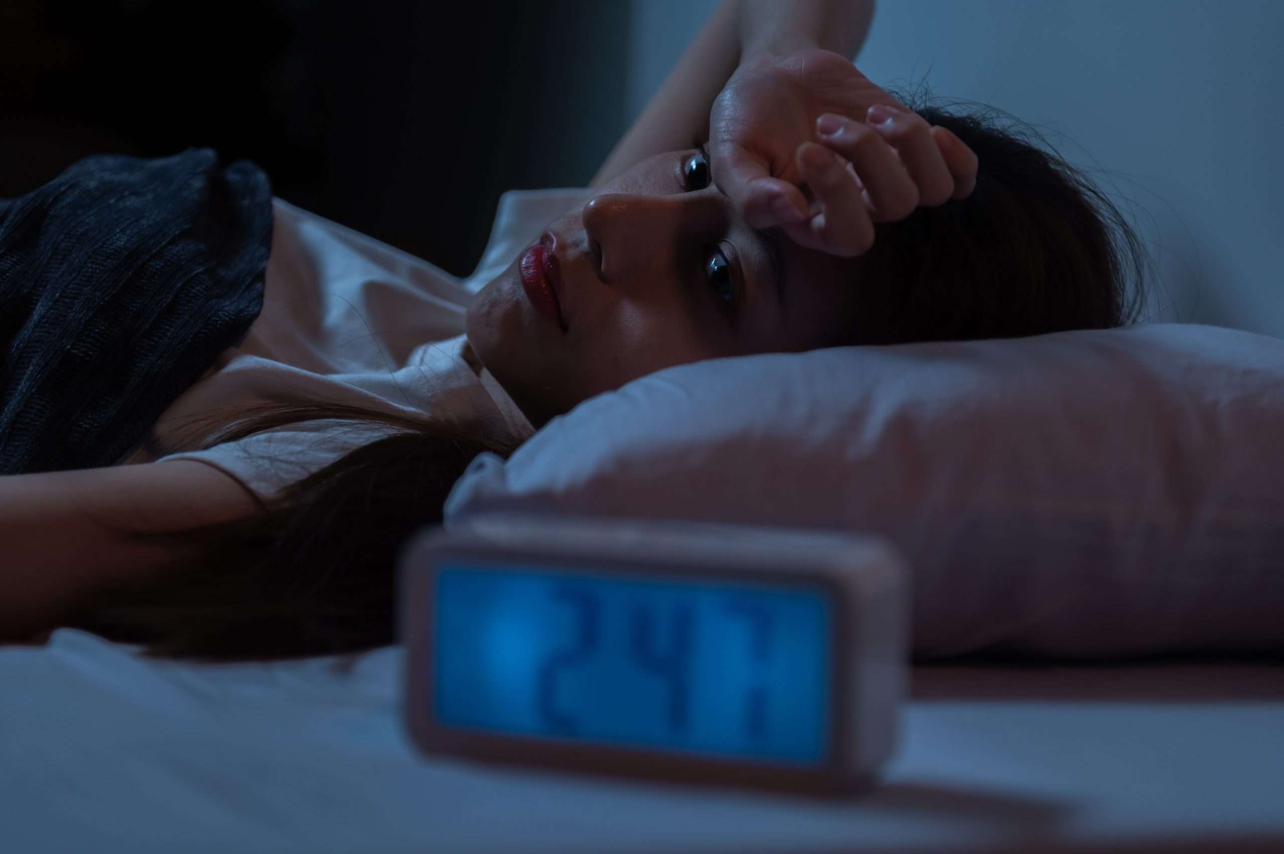 young asian woman suffer from insomnia can't sleep at night awaken from stress mental health problem or migraine. young people health care psychiatry concept.