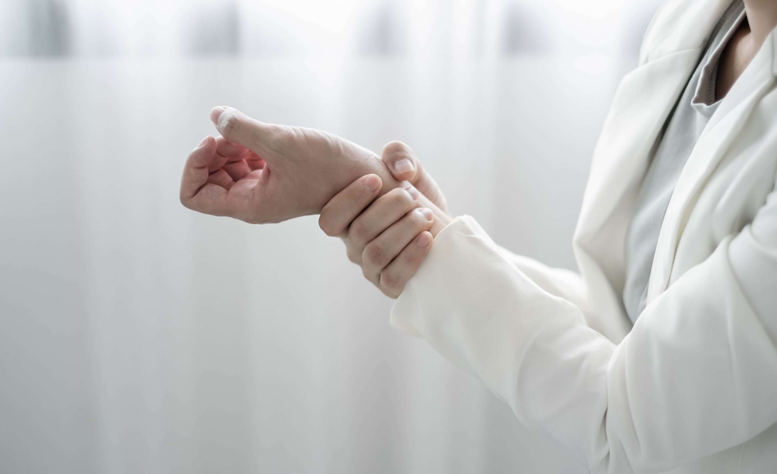 woman hand with wrist pain numbness and pain in the palm of the hand has pain and tingling in the nerve endings this is a side effect of sitting and working for a long time on a laptop at the office
